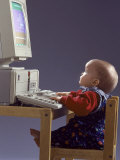 Baby Sitting at Desk Using Computer