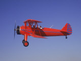 Red Bi-Plane in Flight
