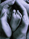 Mother's Hand Holding Baby's Foot