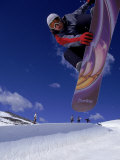Snowboarder with Colorful Board Doing a Trick