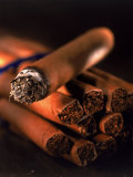 Lit Cigar on Top of Bundle of Cigars
