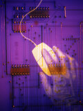 Hand on Computer Mouse with Computer Circuit Board
