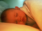 Baby Lying in Bed Sleeping