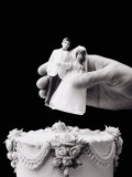 Female Hand Holding Wedding Cake Topper