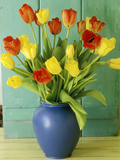 Spring Arrangement  Tulipa in Blue Vase Against Green Door