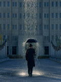 Man with Umbrella Under a Regional Rain