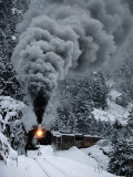 A Train Chugs Through the Snow Blanketing the San Juan Mountains
