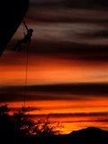 Rock Climber Rappelling off of a Cliff