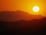 Sunset over Silhouetted Mountain Ridges