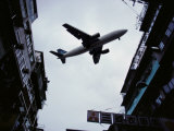 A Jet Soars Above the Crowded Streets of Hong Kong
