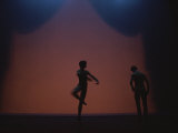 A Silhouetted Ballet Dancer Performs on Stage