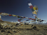 Prayer Flags Blow in the Wind Atop a High Pass on a Tibetan Plateau