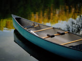 Canoe and Reflections on a Still Lake