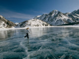 A Girl Ice Skates Across a Frozen Mountain Lake