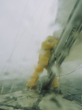 A Sailor Reefs the Boats Mainsail During a Blustery Squall