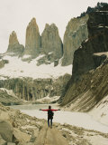 A Hiker with Outstretched Arms is in Awe of the Jagged Landscape