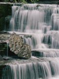 A Time Exposure Captures the Waters Motion as it Falls over Sculpted Rocks