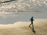 A Jogger Runs Along the Beach