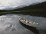 A Canoe Sits Tethered to Shore on a Beautiful Mountain Lake