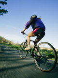 A Bicyclist Rides on a Road