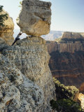 A Man Pretends to Push a Huge Boulder into the Canyon