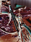 A Cyan Bike against a Bright Red Background