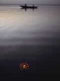 A Flower Offering Floats Past a Boat on the Ganges