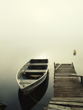 The Morning Sun Shines on a Rowboat Tied to a Dock