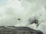 Helicopter Flies over a Smoking Volcano in Hawaii