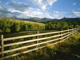 A Rustic Scene of a Fence with Mountains in the Distance in Colorado