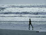 A Person Jogs Along the Beach