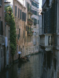 A Gondolier and Two Tourists on a Canal in Venice