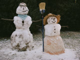 A Pair of Cheerful Snow-People Dressed with Hats  Scarf  Apron  and Broom