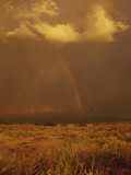 Storm Clouds and a Rainbow Appear over the Prairie Landscape