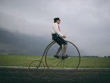 A Man Pedals an Old-Fashioned Bicycle Ahead of an Indiana Thunderstorm