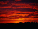 A Sunrise Bathes the Clouds in a Red Glow
