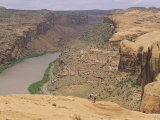 Mountain Bikers on Slickrock Trail Overlooking the Colorado River