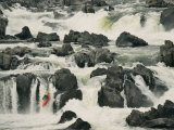 A Kayaker Takes the Last Plunge over a Swift-Flowing Waterfall