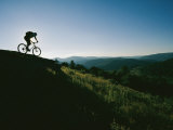 A Bicyclist Rides Along the Ridge of a Mountain