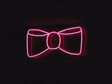A Bright Pink Neon Bowtie Outside a Restaurant