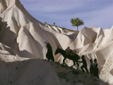 A Turkish Family and Their Donkey Climbing Cappadocia Rock Formations