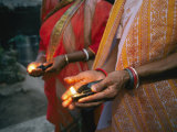 Women Hold Votive Lamps in Their Hands