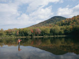 A Fisherman and His Reflection are Surrounded by the Colors of Fall