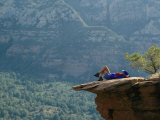 A Hiker Resting at a Cliffs Edge