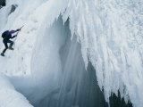 A Man Climbs Outside a Snow Cave