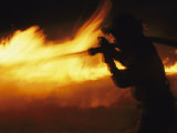 Fire-Fighter Battling a Blaze at Night
