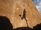 A Runners Shadow Falls on a Rock