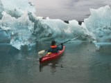 A Kayak Paddler Passes Sculpted Icebergs in Tracy Arm Fjord