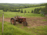 A Tractor Sits in a Farm Field on a Misty Rainy Morning in Springtime  Prince Edward Island  Canada