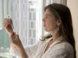 A Woman Draws Medicine into a Syringe